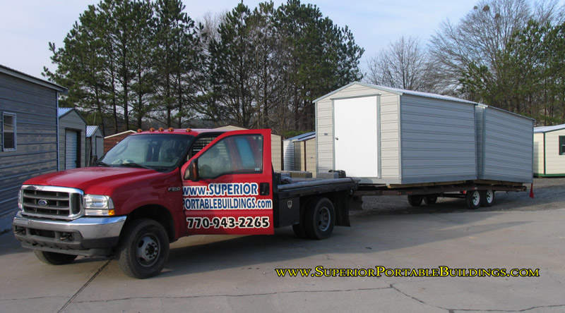 Storage building moving truck and trailers.